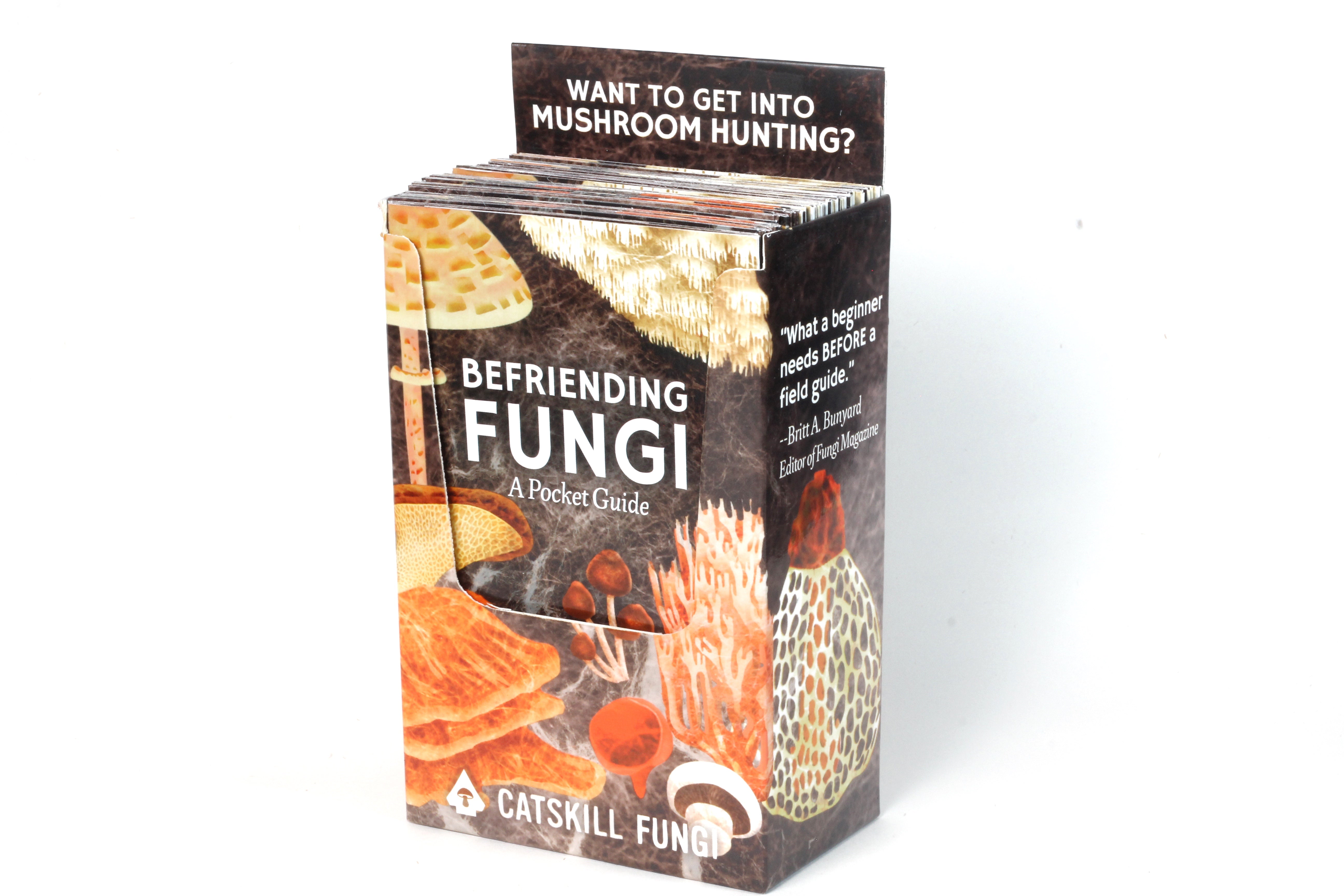 Professional photo of a box containing 25 Befriending Fungi: A Pocket Guide by John Michelotti and Renee Baumann. This accordion folded guide is packaged in a box for viewer to see the amazing display of the box that holds 25 Befriending Fungi A Pocket Guide .The box reads "Want to get into mushroom hunting?"  "What a beginner needs BEFORE a field guide." -Britt A. Bunyard Editor of Fungi Magazine. Catskill Fungi.